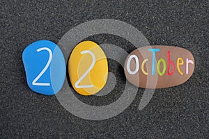 22 October,Â calendar date composed with multi colored stones over beach sand
